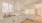 a kitchen with white cabinets a stovetop a sink