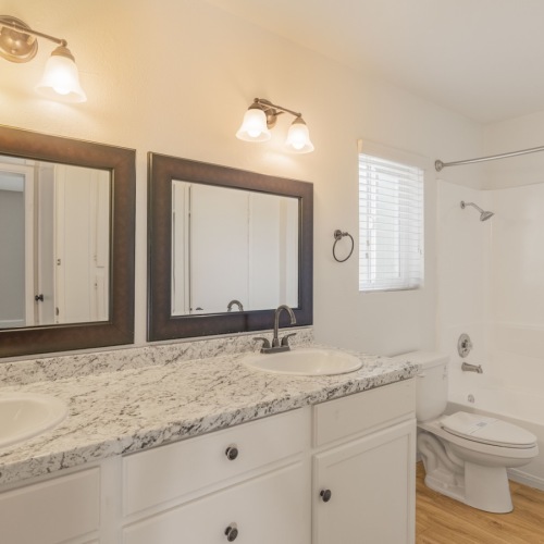Bathroom options with thoughtful details a bathroom with twin sinks a toilet and a tub