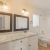 a bathroom with twin sinks a toilet and a tub