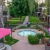 a hot tub in a courtyard with umbrellas