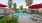 a swimming pool in a courtyard with umbrellas