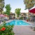 a swimming pool in a courtyard with umbrellas