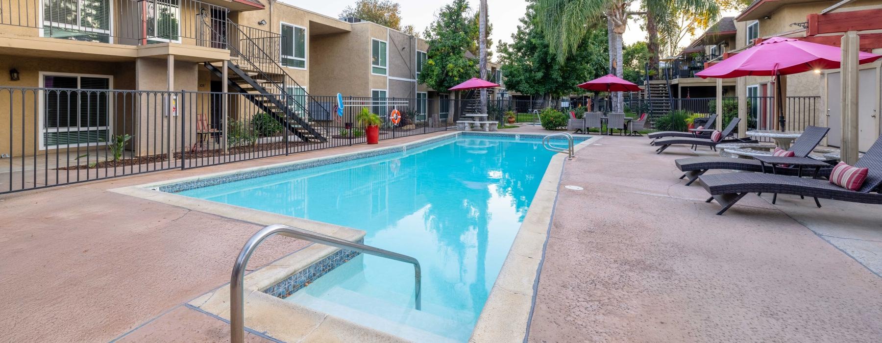 a swimming pool with poolside lounge seating